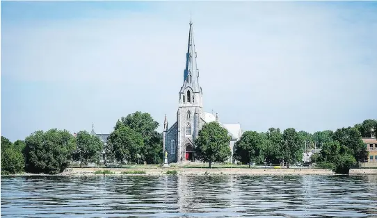  ?? PHOTO COURTESY OF THE CITY OF POINTE-CLAIRE ?? St. Joachim Church, at 2 Ste-Anne Ave., whose stone facade and dramatic steeple are reflected in the waters of Lac St-Louis, forms one of the defining images of Pointe-Claire. Another is the historic windmill at 5 St-Joachim Ave. (below, right); built...