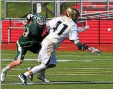  ?? AUSTIN HERTZOG — DIGITAL FIRST MEDIA ?? Spring-Ford’s Justin Schwenk flips the faceoff to himself against Bishop Shanahan.