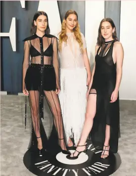  ?? Jean-Baptiste Lacroix / AFP / Getty Images ?? The Haim sisters are (from left) Danielle, Este and Alana.
