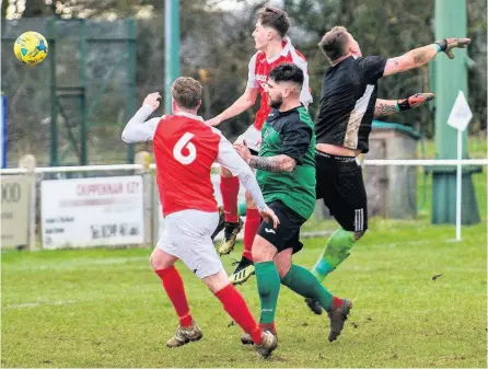  ?? PICTURES: Artur Lesniak ?? Jake Dodge climbs above the Cricklade goalkeeper to net for Corsham Town Reserves, who won the Wiltshire League clash 5-0