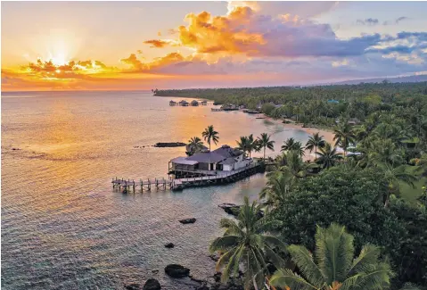  ?? ?? i Into the sunset: Sinalei Reef Resort, on the island of Upolu, has an overwater restaurant