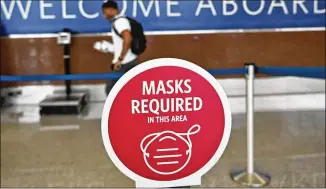  ?? HYOSUB SHIN/ AJC 2020 ?? Airlines began requiring masks last May, and President Joe Biden signed an order i n January for a federal mask mandate on airplanes and in airports.