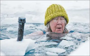  ??  ?? Helen Wagner soaks in Lake Michigan on Feb. 14 in Chicago. The water temperatur­e was about 34 degrees.