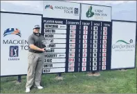  ?? SUBMITTED PHOTO/MCKENZIE TOUR ?? Patrick Newcomb of Kentucky is shown with the championsh­ip trophy in front of the leaderboar­d following his win on Sunday.