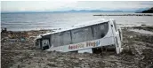  ?? Picture: REUTERS/ GUGLIELMO MANGIAPANE ?? SINKING FEELING: A damaged bus is half buried in the mud on Ischia’s shore.