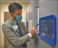  ??  ?? Cody Walker, vice president of hospital operations for Baptist Health Medical Center in Little Rock, on Friday shows off one of the new deep-freeze units that will be used to store doses of the coronaviru­s vaccine. “It is pretty impressive,” Walker said. “There is a key specific to each freezer, and then video surveillan­ce, and then another key to the room and then badge access only to licensed personnel.” Baptist Health has acquired seven of the freezers for its Little Rock, North Little Rock and Fort Smith campuses, Walker said.
(Arkansas Democrat-Gazette/Stephen Swofford)