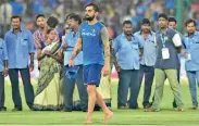  ?? — PTI ?? Groundsmen look dejected as they watch Virat Kohli walk past