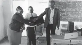  ??  ?? Tsholotsho North Member of Parliament and Minister of Higher and Tertiary Education, Science and Technology Developmen­t Professor Jonathan Moyo hands over computers to a representa­tive of one of the seven secondary schools in his constituen­cy that...
