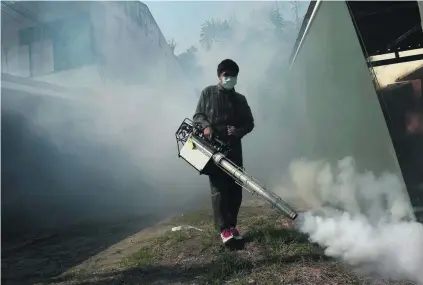  ?? Christophe Archambaul­t / AFP ?? A Bangkok neighbourh­ood is fumigated against mosquito as to prevent Zika and dengue fever.