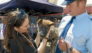  ?? PHOTO: ROSS GIBLIN/STUFF ?? Prime Minister Jacinda Ardern meets police dog pup Hana, with Sergeant Ben O’Connor at graduation day.