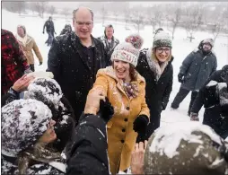  ?? STEPHEN MATUREN — GETTY IMAGES ?? Sen. Amy Klobuchar, D-Minn., greets supporters with her husband, John Bessler, left, and daughter Abigail Bessler after announcing her presidenti­al bid Sunday in a cold and snowy Minneapoli­s.