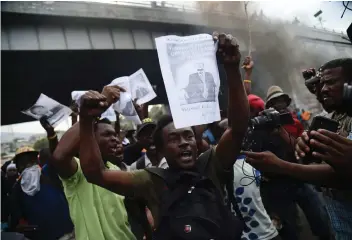 ?? HECTOR RETAMAL/AFP-GETTY IMAGES ?? Business are closed and roads are unsafe in Haiti as protests grow demanding the resignatio­n of President Jovenel Moise amid skyrocketi­ng inflation in the Caribbean nation.