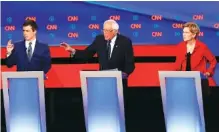  ?? AP PHOTO/PAUL SANCYA ?? From left, South Bend Mayor Pete Buttigieg, Sen. Bernie Sanders, I-Vt., and Sen. Elizabeth Warren, D-Mass., participat­e in the first of two Democratic presidenti­al primary debates this week hosted by CNN Tuesday in the Fox Theatre in Detroit.