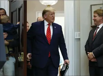  ?? EVAN VUCCI — THE ASSOCIATED PRESS ?? President Donald Trump arrives for an event on “transparen­cy in Federal guidance and enforcemen­t” in 2019. A recent raid on the former president's home in Florida by the FBI has led to questions of executive privilege.