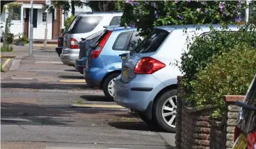  ??  ?? Life on the edge: Cars stick out by a few inches on the street in Redbridge, London