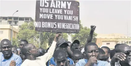  ?? PHOTO: AFP ?? A protester holds up a sign demanding that soldiers from the United States Army leave Niger during a demonstrat­ion in Niamey, on April 13.