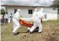  ?? PICTURE: EPA ?? HELPING HANDS: A Liberian Red Cross burial team retrieves the body of a suspected victim of Ebola in Banjor, on the outskirts of Monrovia, Liberia in October 2014.