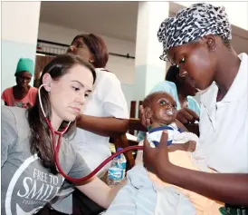  ??  ?? A Free to Smile Foundation doctor from the United States assesses baby Shylene Moyo while the mother, Zanele Dube, looks on at Mpilo Central Hospital in Bulawayo last week.The doctors are conducting cleft lip repair surgery for free at the hospital...