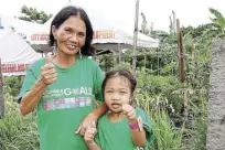  ??  ?? Valeriana Almonte, together with her five-year-old grandchild, Miles, pose for a photo as one of the SDG-FACES Beneficiar­ies.