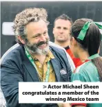  ??  ?? > Actor Michael Sheen congratula­tes a member of the winning Mexico team