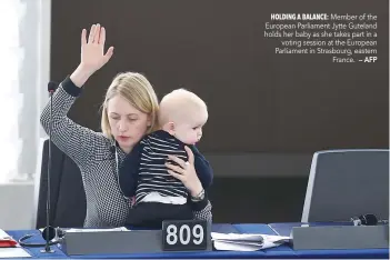  ?? — AFP ?? Member of the European Parliament Jytte Guteland holds her baby as she takes part in a voting session at the European Parliament in Strasbourg, eastern France.