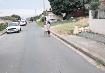  ?? Pictures: GCINA NDWALANE ?? Inderlall Rabilall, above left, want eThekwini Municipali­ty to put speed humps in Crocus Road. He says speeding motorists present a risk to children using the road. Walking down the road are Sivash and Maheshni Gopal.