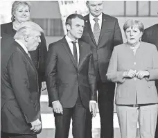  ?? ERIC FEFERBERG, AFP/GETTY IMAGES ?? President Trump joins French President Emmanuel Macron and German Chancellor Angela Merkel Thursday in Brussels.
