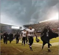  ?? CHARLES REX ARBOGAST — THE ASSOCIATED PRESS ?? Ravens players leave the field in 2013 after play was suspended for a thundersto­rm blowing through Soldier Field in Chicago.