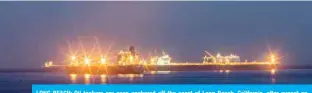  ??  ?? LONG BEACH: Oil tankers are seen anchored off the coast of Long Beach, California, after sunset on Saturday. Companies are using the tankers to store excess supplies of crude oil due to lack of demand during the novel coronaviru­s pandemic, US media reported. — AFP