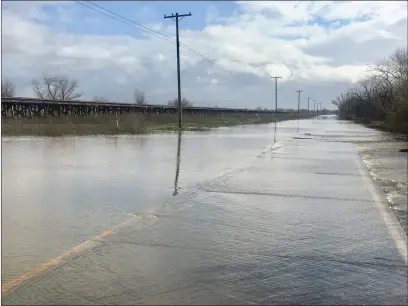  ?? DAILY DEMOCRAT ARCHIVES ?? Old River Road is often closed when water levels in the Yolo Bypass rise.