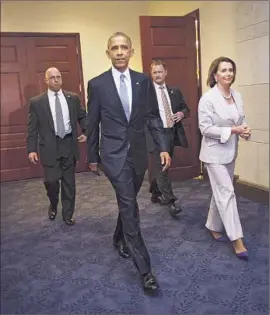  ?? Pablo Martinez Monsivais Associated Press ?? PRESIDENT OBAMA and House Minority Leader Nancy Pelosi leave a Capitol Hill meeting with House Democrats. Pelosi voted against a retraining bill.