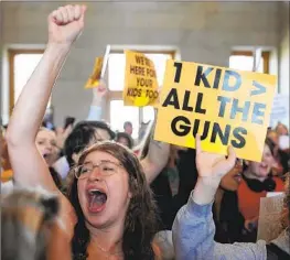  ?? George Walker IV Associated Press ?? PROTESTERS outside Tennessee’s House chamber in Nashville denounce the passage Tuesday of a bill that would let some school staff carry concealed guns.