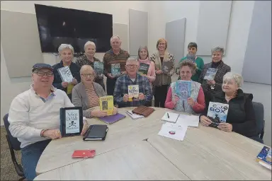  ?? Flip Putthoff/NWA Democrat-Gazette ?? Hidden Gems Mystery Book Club members show their books. Members are (front row, from left) Rob Berg, Joan Lehner, Don Towers, Betty Hall, Myrlene Zimmerman, (back) Pat Kirby, Sandy Gromatka, Mark Lloyd, Mary Green, Anne Worrell, Danatte Brunet and Barbara Cantara.