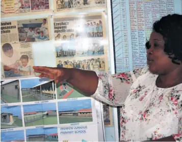  ??  ?? School Principal Julie Mdluli shows off newspaper cuttings relating to Ingweni Primary