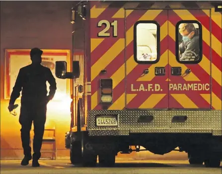  ?? Genaro Molina Los Angeles Times ?? PARAMEDICS ARRIVE with a patient at the Adventist Health-White Memorial emergency room on Thursday in Los Angeles’ Boyle Heights neighborho­od. Deaths from COVID-19 have been surging in L.A. County and the rest of California since the Christmas holiday.