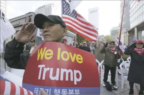  ?? AHN YOUNG-JOON— THE ASSOCIATED PRESS ?? Protesters against North Korea salute during a rally welcoming the planned visit by U.S. President Donald Trump in Seoul, South Korea, on Saturday. Grand receptions are reportedly planned for his arrival in Tokyo, Seoul and Beijing on a trip that also...