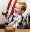  ?? ?? Jordan Petty, 6, strikes the gavel during the ceremony.