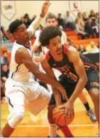  ?? ROB DUDLEY — SPECIAL TO THE TIMES ?? Marple Newtown’s Marcus Weathers, left, defends Penncrest’s A.J. Taylor on Dec. 11. Weathers is one of the senior leaders helping the Tigers transition from the change of leadership of the program, with Eric Houck coaching the team on an interim basis...