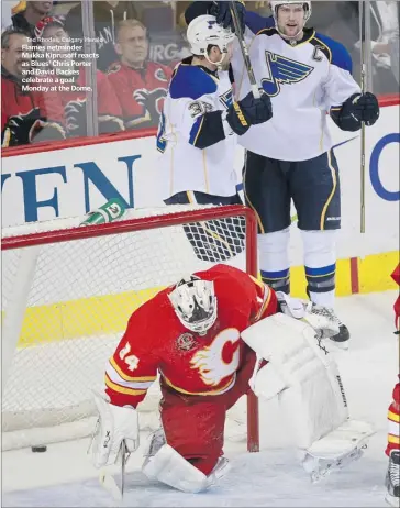  ?? Ted Rhodes, Calgary Herald ?? Flames netminder Miikka Kiprusoff reacts as Blues’ Chris Porter and David Backes celebrate a goal Monday at the Dome.