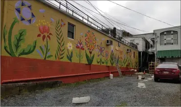  ?? MICHELLE N. LYNCH— MEDIANEWS GROUP ?? Art students from Kutztown University and Kutztown High School spent Friday, April 23, and Saturday, April 24, painting a mural on Sander Alley in the borough.