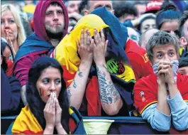  ??  ?? Belgian supporters react as they gather at a fan zone in Brussels.