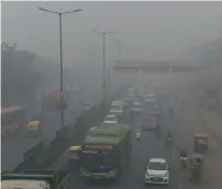  ?? AFP file ?? Motorists drive on a major road as smog covers the capital’s skyline in New Delhi. —