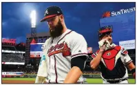  ?? AP/JOHN AMIS ?? Atlanta pitcher Dallas Keuchel (left) kept himself in shape before signing with the Braves, which has led to success on the field that hasn’t translated to many victories.