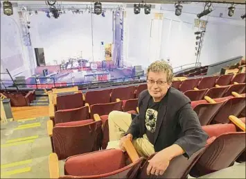  ?? Paul Buckowski / Albany Times Union ?? Jonathan Newell, founder and executive and artistic director of the Hudson River Music Hall Production­s Inc., sits in the balcony inside the Hudson River Music Hall Strand Theatre in 2019 in Hudson Falls. The building was last used as the Kingsbury Town Hall before the Hudson River Music Hall Production­s Inc. purchased the building.