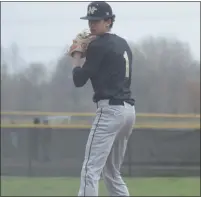  ??  ?? L’Anse Creuse North sophomore Josh Midbo checks the runner at first base before pitching against Anchor Bay in Monday’s game.