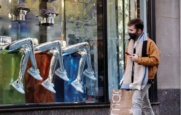  ?? ?? ↑
A man shops on 5th Avenue in New York, US.
Reuters