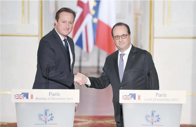 ??  ?? PARIS: French President Francois Hollande (right) and British Prime Minister David Cameron shake hands after a joint statement following talks yesterday at the Elysee Presidenti­al Palace. —AFP