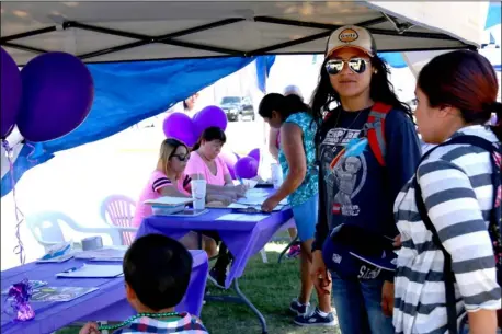  ?? WILLIAM ROLLER PHOTO ?? FROM RIGHT: Crystal, Jasmine and Jesus Granado visit Between Women informatio­n tables to learn more about cancer treatment options Saturday at the Brawley Cancer Walk Kickoff in North Plaza.