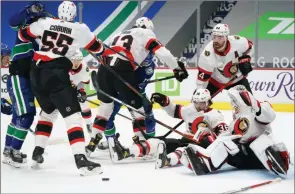  ?? The Canadian Press ?? Ottawa Senators goaltender Matt Murray stops a Vancouver Canucks’ shot in Vancouver on Thursday.