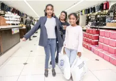  ??  ?? CINDY Naicker helps her daughter, Kiana, try on a school blazer.